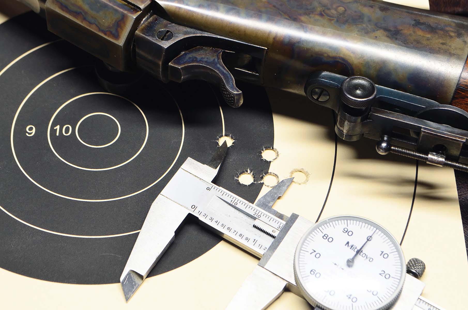 This five-shot group (at 50 yards), measures exactly 1.20 inches and was shot with factory sights. The first four went into the small cluster. Two fliers followed, so I wiped the bore with a wet patch, and the last shot went back into the group, enlarging it slightly.